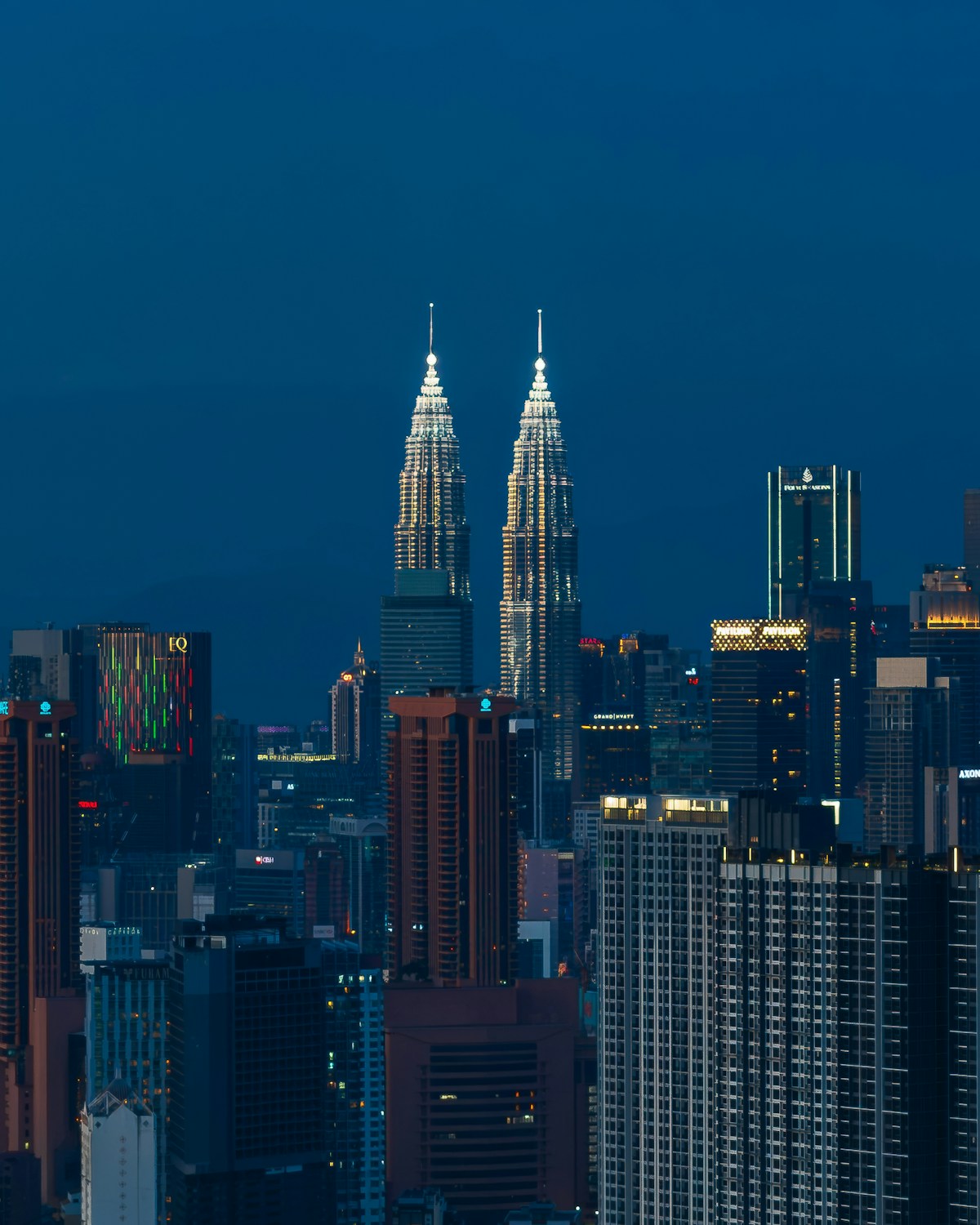 Petronas Twin Towers rising above Kuala Lumpur at dusk