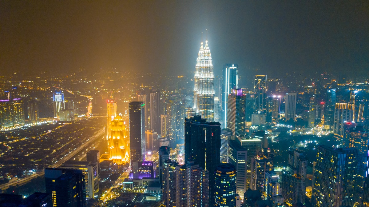 Kuala Lumpur city skyline at night with Petronas Twin Towers illuminated, Malaysia