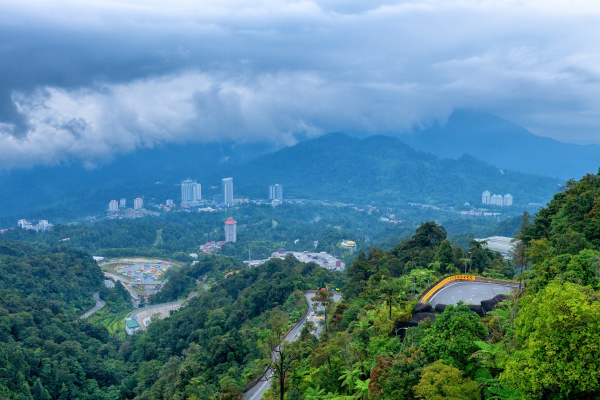 Winding mountain road through rainforest mist near Genting Highlands, Malaysia