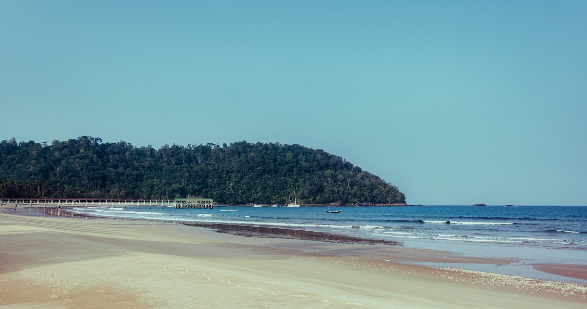 Sandy beach with a small island in the distance, Tioman Island, Malaysia