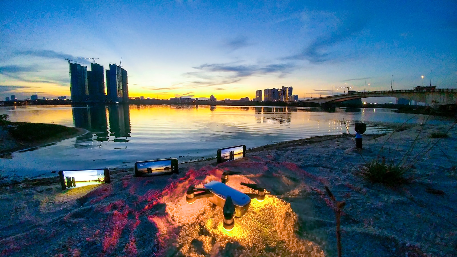 Johor Bahru city skyline at sunset reflected in water, with bridge, Johor, Malaysia