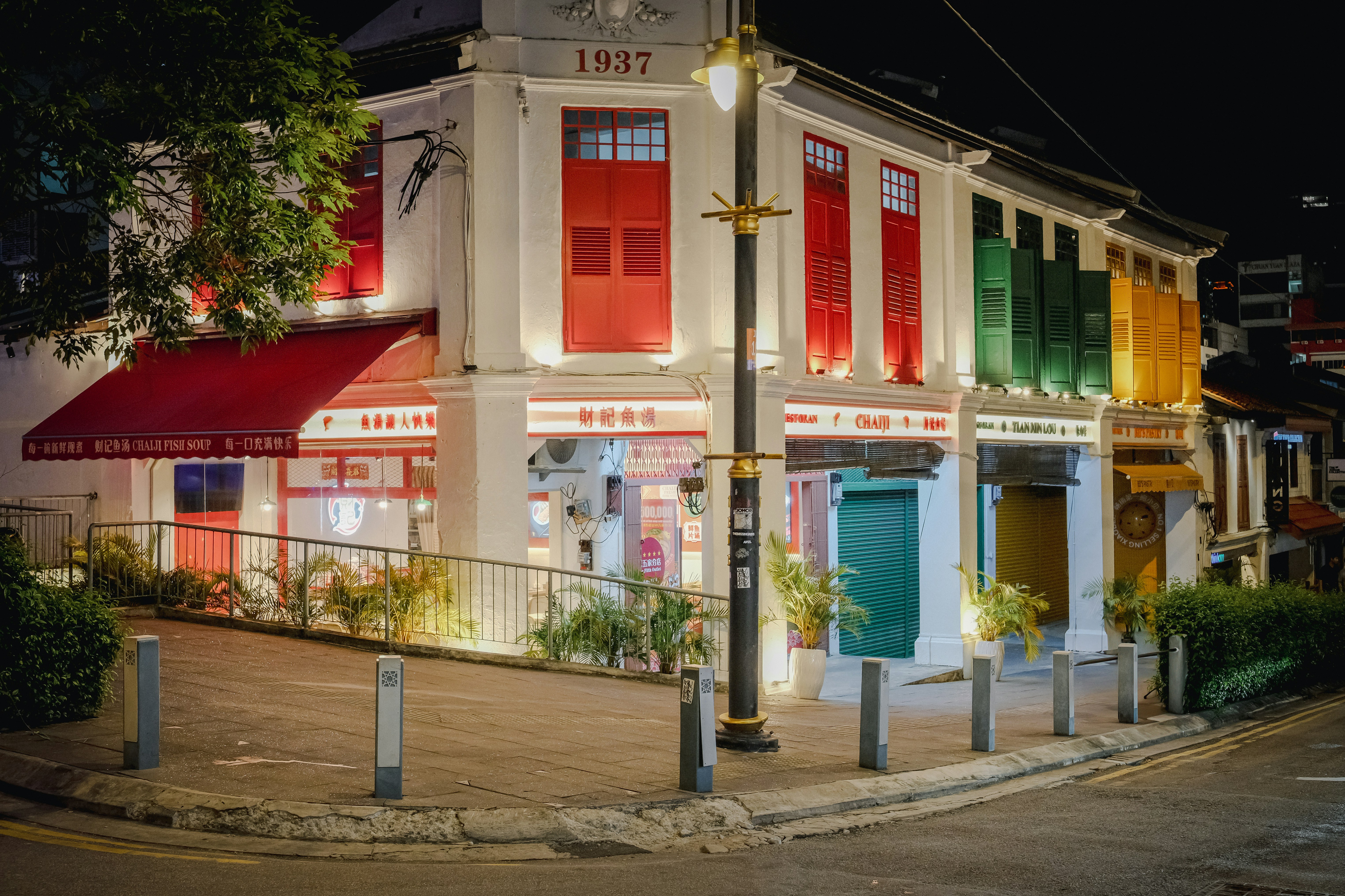 Colourful heritage shophouses lit up at night in Johor Bahru, Malaysia
