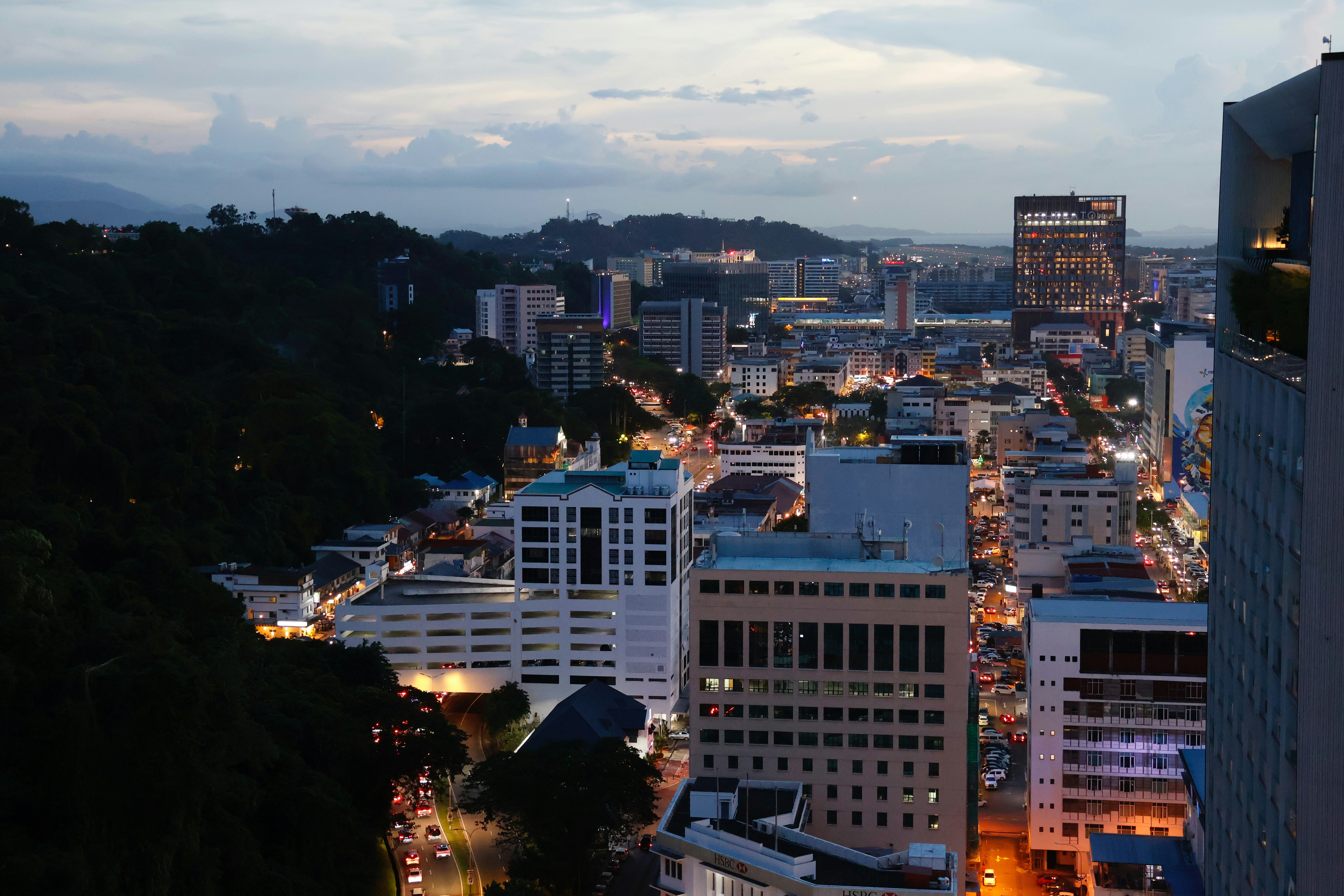 Kota Kinabalu city skyline with buildings illuminated at dusk, Sabah, Malaysia