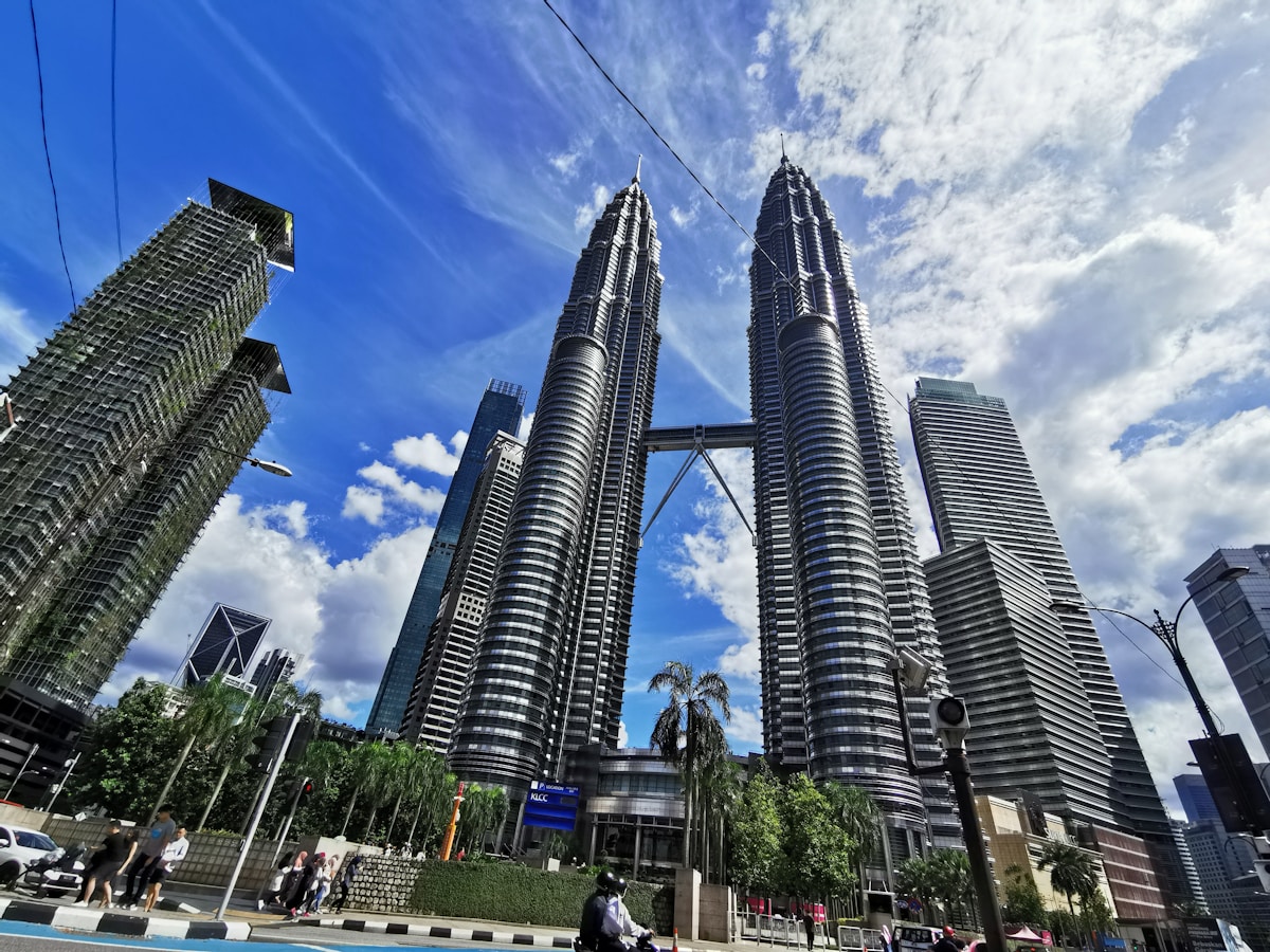 People walking on street near high rise buildings, Kuala Lumpur, Malaysia