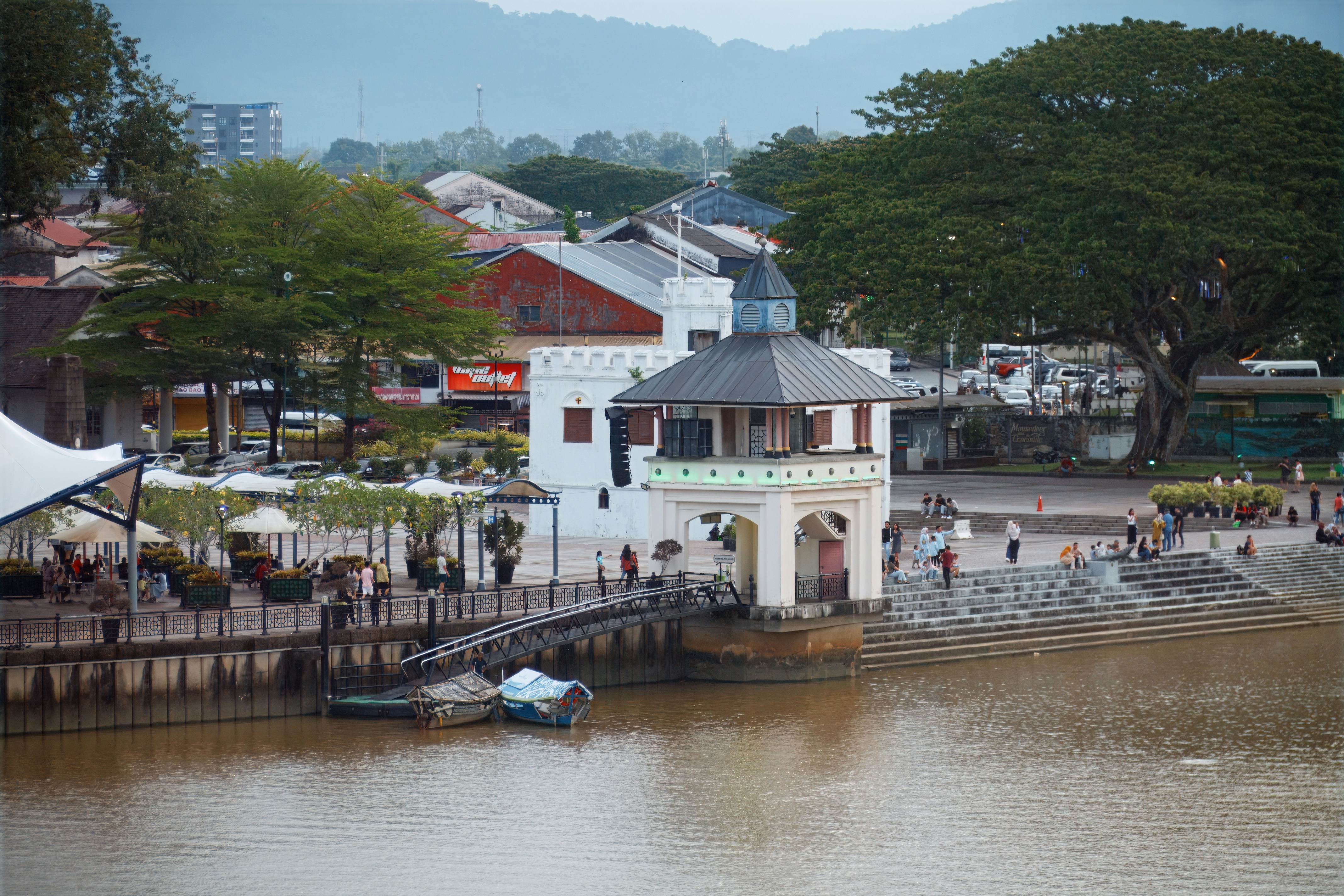 Kuching Waterfront building on the Sarawak River with green trees, Malaysia