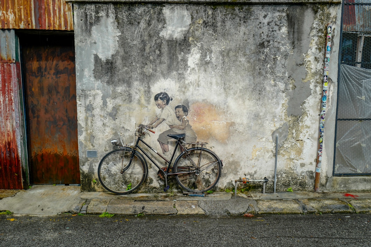 Mural painted on a weathered shophouse wall in George Town, Penang