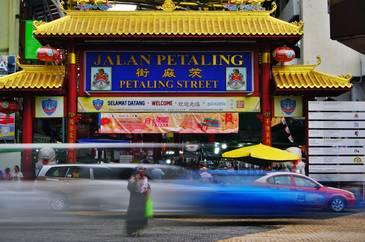 Jalan Petaling street archway with blurred traffic, Kuala Lumpur, Malaysia