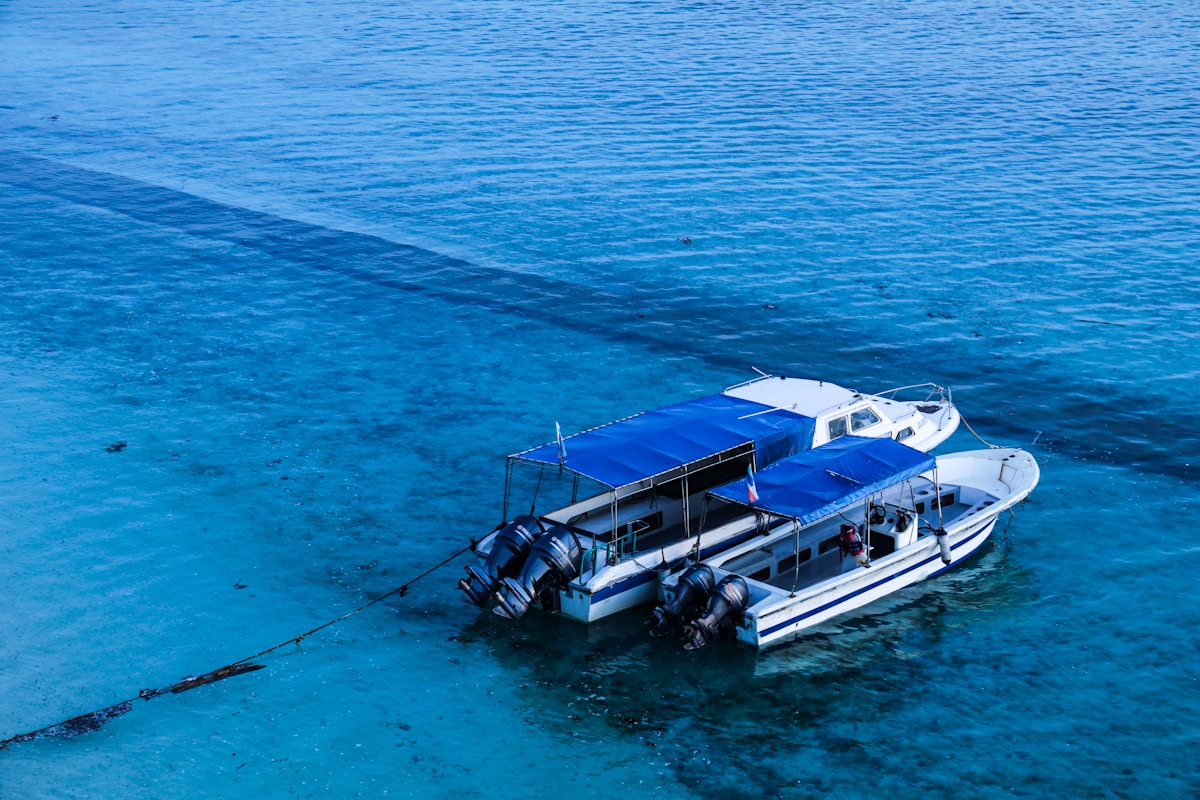 Overwater bungalows and clear turquoise water at a dive resort near Semporna, Sabah
